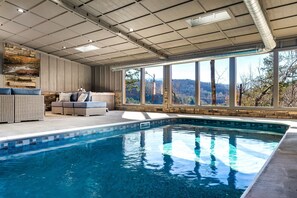 Relax by the pool surrounded by a serene landscape and natural surroundings.