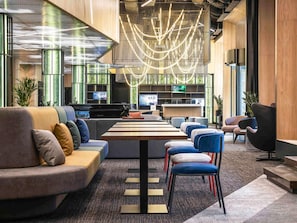 A modern lobby with a piano, seating areas, and a reception desk. - Novotel Living Almaty Jetisu (Almaty)