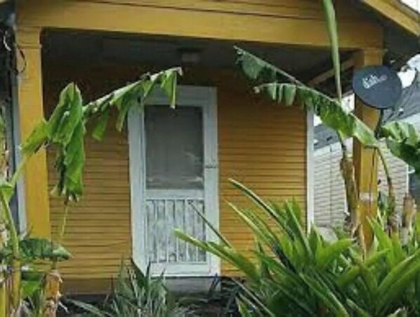 Stunning residential property with a charming porch and lush garden surroundings.