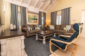 A living room with two sofas, a coffee table, and a chair. - Paradise Villa|Gated|Pool|Richmond (Ocho Rios)