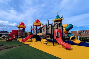 A playground with slides and climbing structures. - Paradise Villa|Gated|Pool|Richmond (Ocho Rios)