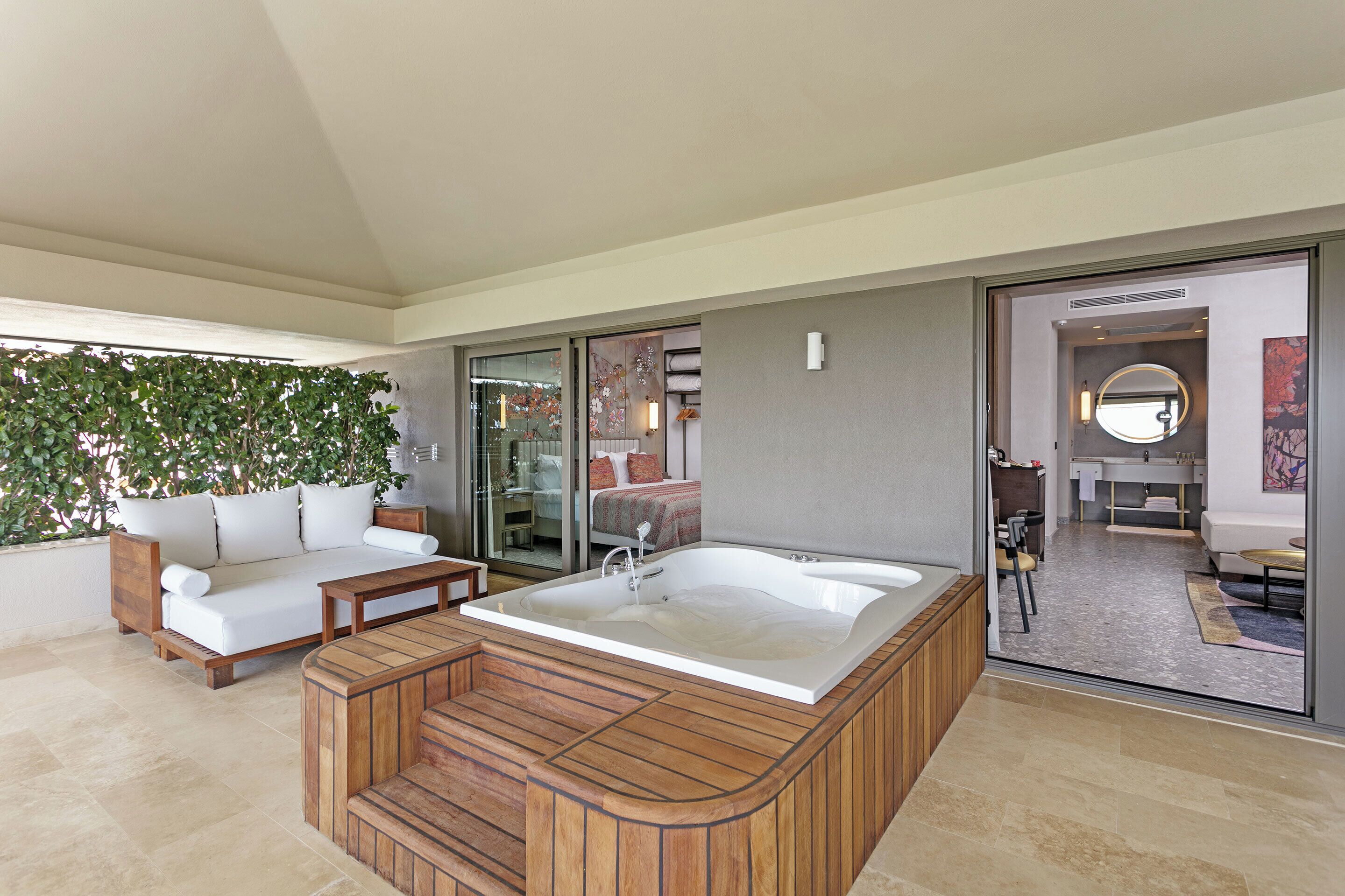 A modern bathroom with a large bathtub, a shower area, and a toilet.