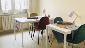 A dining area with a table, chairs, and wall decor.