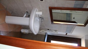 A bathroom with a white sink, a mirror, and a towel rack. - Amalfi double room (Gragnano)