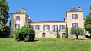 A large, historic building with symmetrical architecture, featuring two towers and a central entrance with a staircase. - In the heart of Vineyards (LA REOLE)