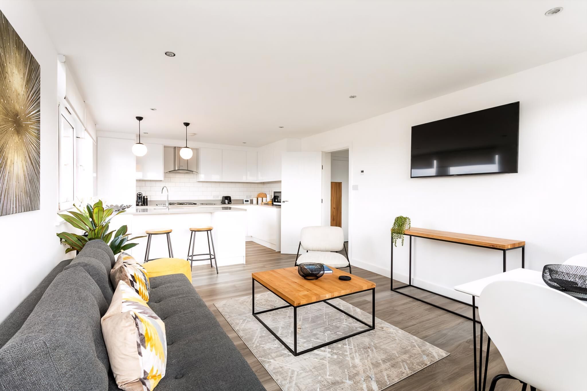 A modern living room with a sofa, coffee table, and TV.