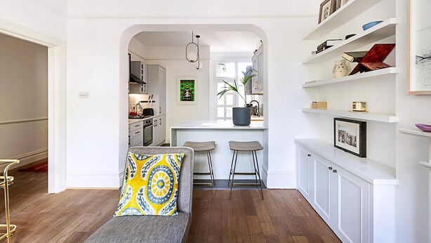 A modern interior with a sofa, a kitchen, and a bar area. - Stunning Maida Vale Apartment (London)