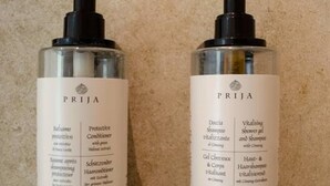 Two bottles of PRIJA hair care products on a textured surface. - Homely Stay Studio1 - Your place to relax (München)