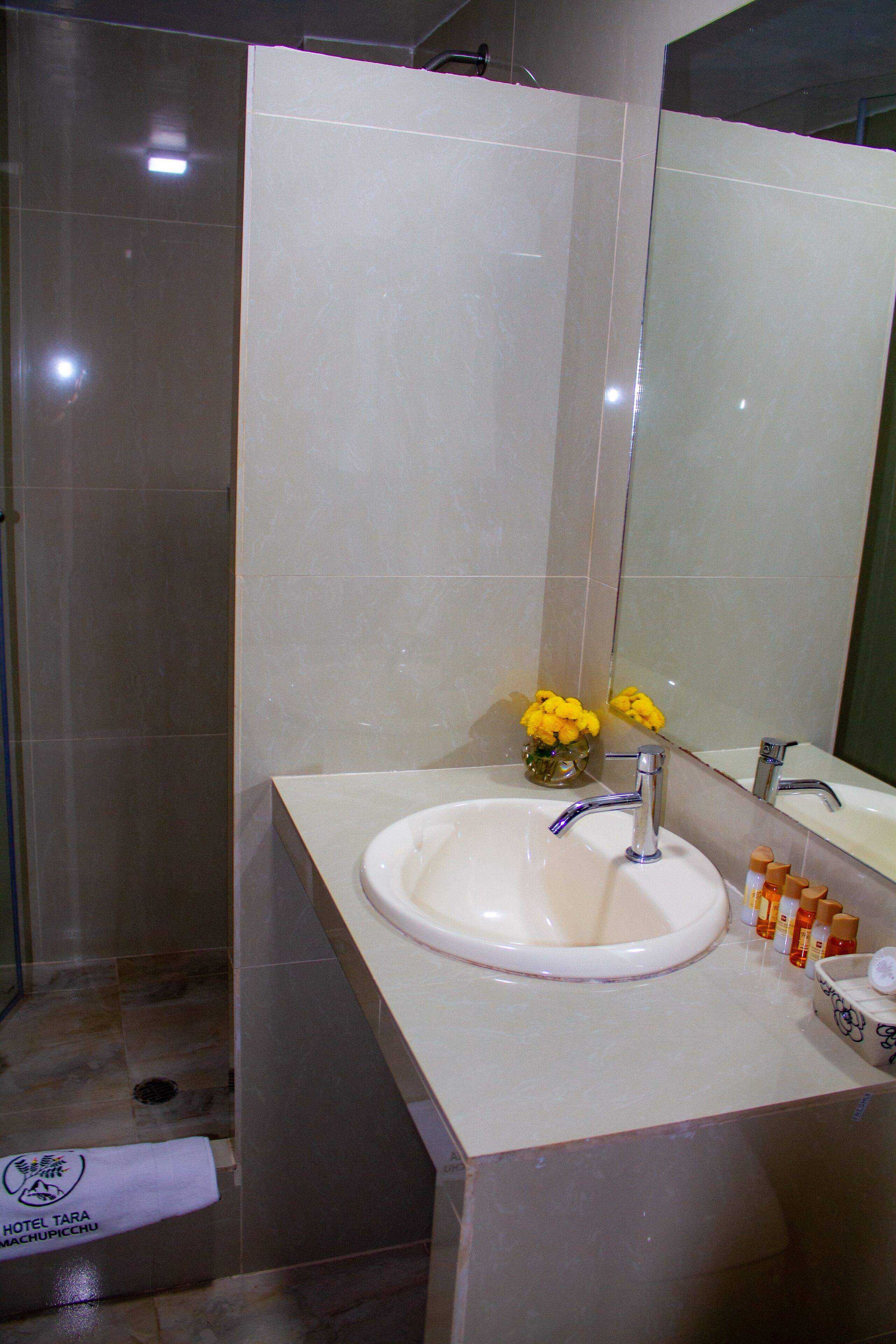 superior single room | bathroom | shower, rainfall showerhead, hair dryer, towels