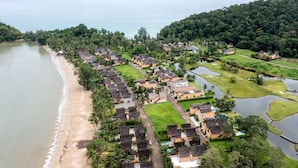 An aerial view of a coastal resort with beachfront villas, a golf course, and a lake. - Siam Royal View Pool Villa by PSR ASIA (Ko Chang)