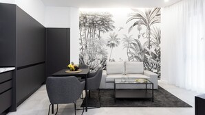 A modern living space with a dining area, a sofa, and a coffee table.