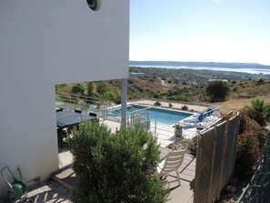A pool area with a view of the surrounding landscape.