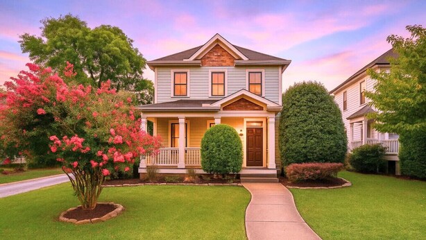 A two-story house with a front porch, a driveway, and a well-maintained lawn. - Southern City Comfort - Huge Private Backyard (Nashville)