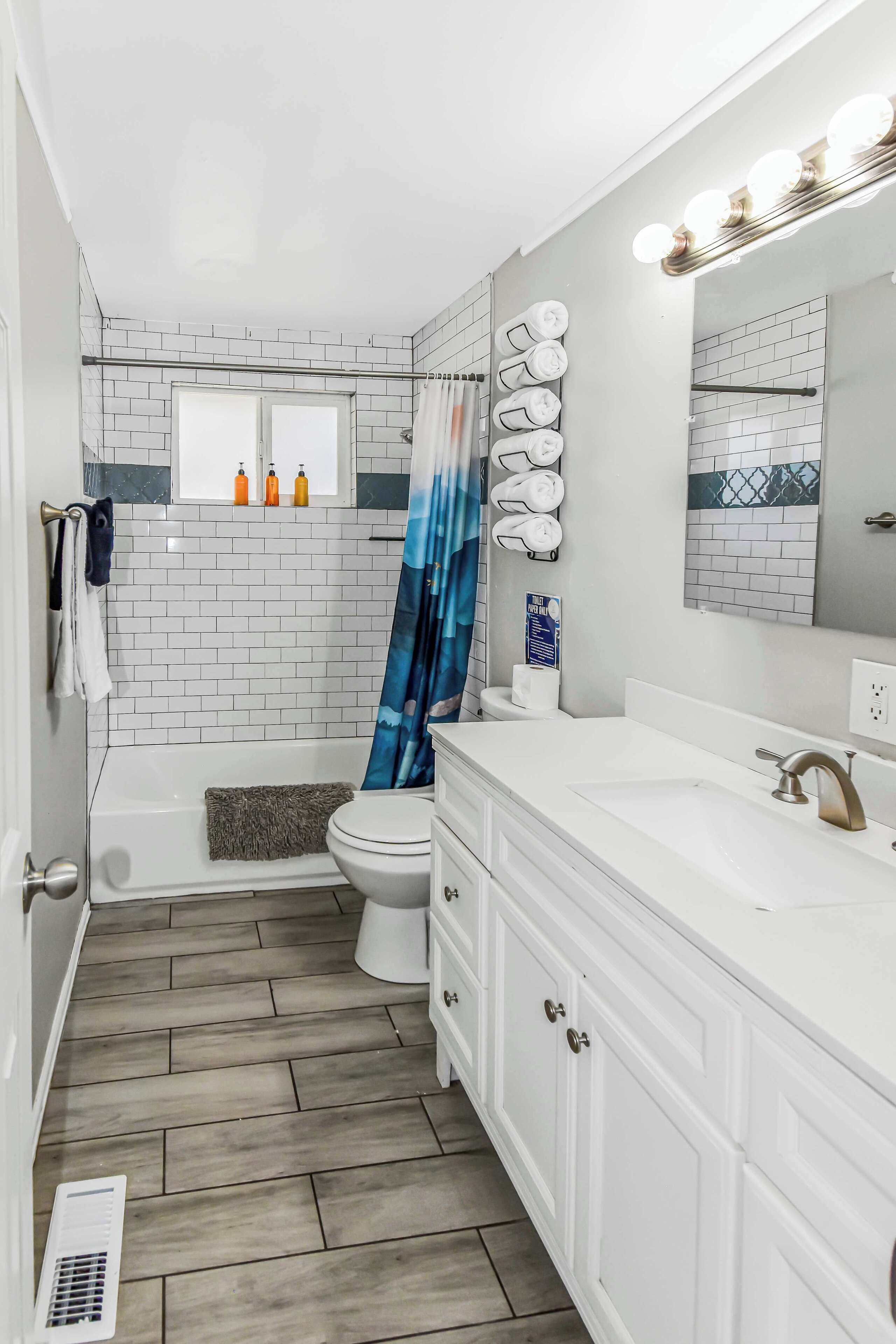 Bathtub, hair dryer, towels, shampoo