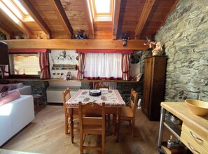 Cozy space with a high ceiling, dining area, and comfortable seating, offering a warm and inviting atmosphere.