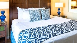A hotel room with a large bed, two bedside tables, and a headboard. - Two Bedroom Ocean Front Condo, Ormond Beach 2555514 (Ormond Beach)