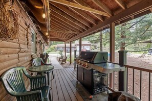 A covered outdoor area with a grill, seating, and a view of the surrounding landscape. - Lakefront Home-Stunning Views-Hot Tub, 3100 sqft! (Wakefield)