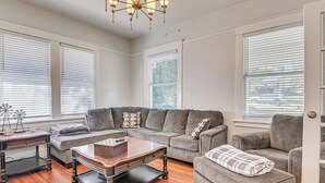 A living room with a sectional sofa, a coffee table, and a fireplace.