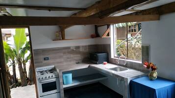 Fridge, microwave, coffee/tea maker, cookware/dishes/utensils