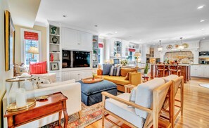 Relax in a comfortable living space with sofas, armchairs, and a dining area.