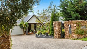 A stone wall with a sign reading "KAMALA" and a house with a gravel driveway. - KAMALA - MOUNT ELIZA (Mount Eliza)