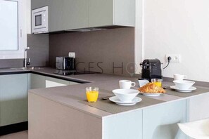 A modern kitchen with a built-in island, a microwave, and a coffee maker.