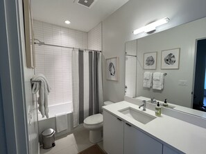 Combined shower/tub, hair dryer, towels, soap