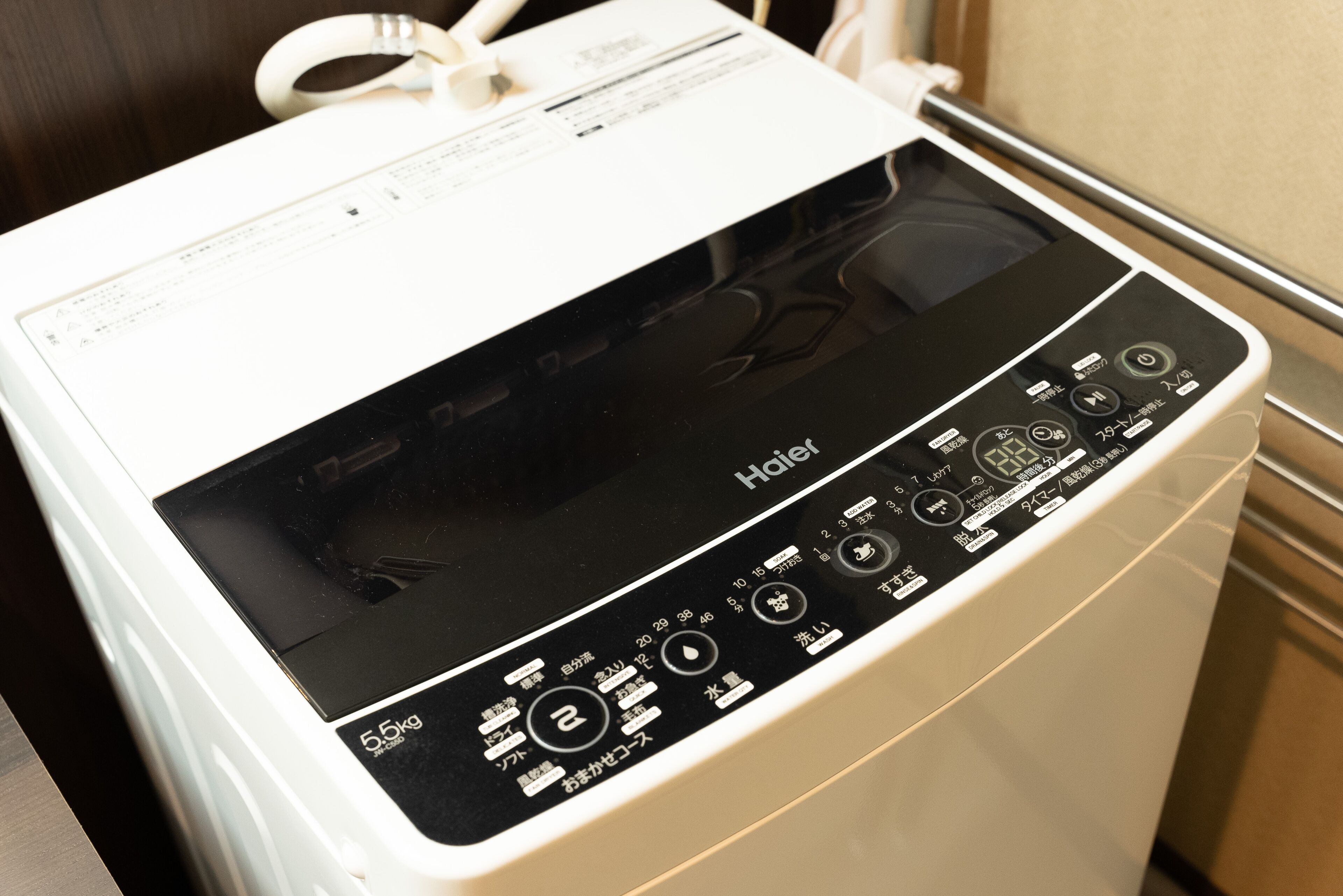 A white and black electric kettle with a control panel and a power cord.