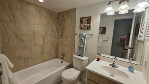 Combined shower/tub, hair dryer, towels, soap