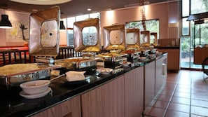 Enjoy a sumptuous spread of international cuisine at our dining area, featuring a variety of dishes served from the buffet counter.