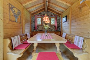 Cozy interior with a high ceiling, wooden table, and wooden paneling.