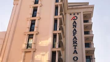 Classic hotel exterior with a prominent sign and symmetrical facade.