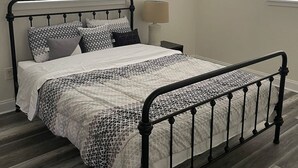 A bedroom with a metal bed frame, a ceiling fan, and two windows with blinds. - 3 bedroom House in a quiet neighborhood (Orlando)