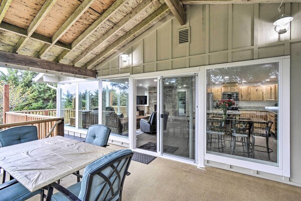 Enjoy meals or drinks in this sheltered outdoor space with a dining table and chairs.
