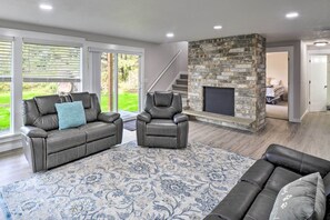 Relax in style with a comfortable seating arrangement and a fireplace, perfect for unwinding or entertaining guests.