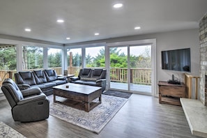 Relax in this spacious living room with a sofa, recliner, and flat-screen TV.