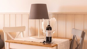 A table with a bottle of wine, two glasses, a lamp, and a chair. - 'Sunny Apartment Front Line Burriana' Near the Beach with Sea View, Wi-Fi, A/C & Balcony (Nerja)