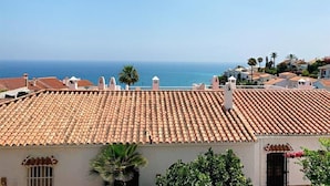 A coastal town with terracotta-tiled rooftops, a clear sky, and a view of the sea. - 'Wonderful House by the sea' with Sea & Mountain View, Pool and Wi-Fi (Nerja)