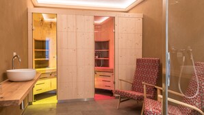 A bathroom with a wooden vanity, a sink, and a chair. - Apartment 'Hilber Fermeda' with Mountain View, Private Terrace and Wi-Fi (Villnöss)