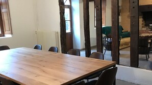 A conference room with a large wooden table and several chairs.