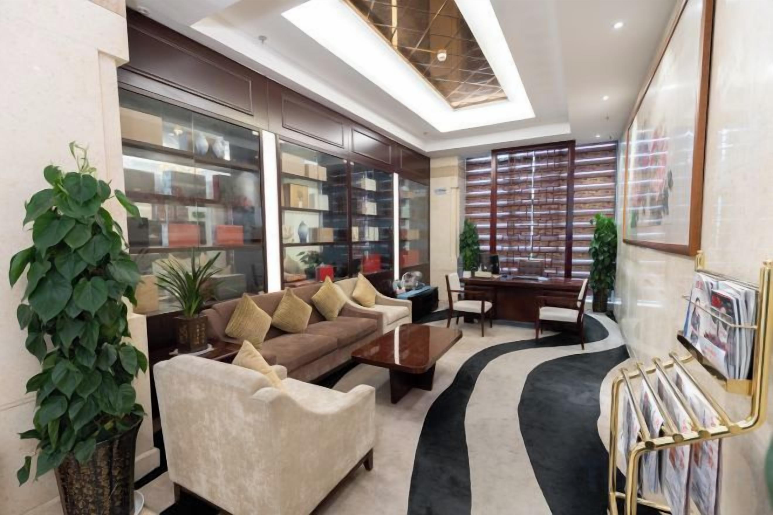 A modern living room with a sofa, coffee table, and a bookshelf.