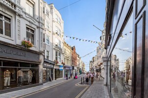 A street with shops, including 'The Whiskery Shop' and 'Halffields'.