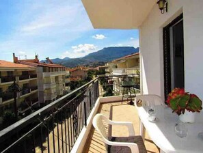 Enjoy the serene views of the surrounding mountains from this balcony.