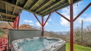 A hot tub under a covered patio with a view of mountains. - Upscale Home With Expansive Mountain Views (Banner Elk)