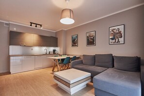 Comfort appartement | Woonruimte | Een 40-inch flatscreentelevisie met digitale zenders en een televisie