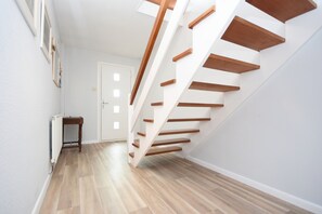 A modern staircase with wooden steps and white walls. - Sea Breeze, Selsey -  a town house that sleeps 6 guests  in 3 bedrooms (Chichester)