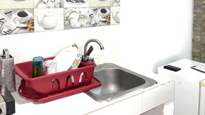 A kitchen with a sink, a red dish rack, and a white countertop. - Welcome to real paradise (San Luis)