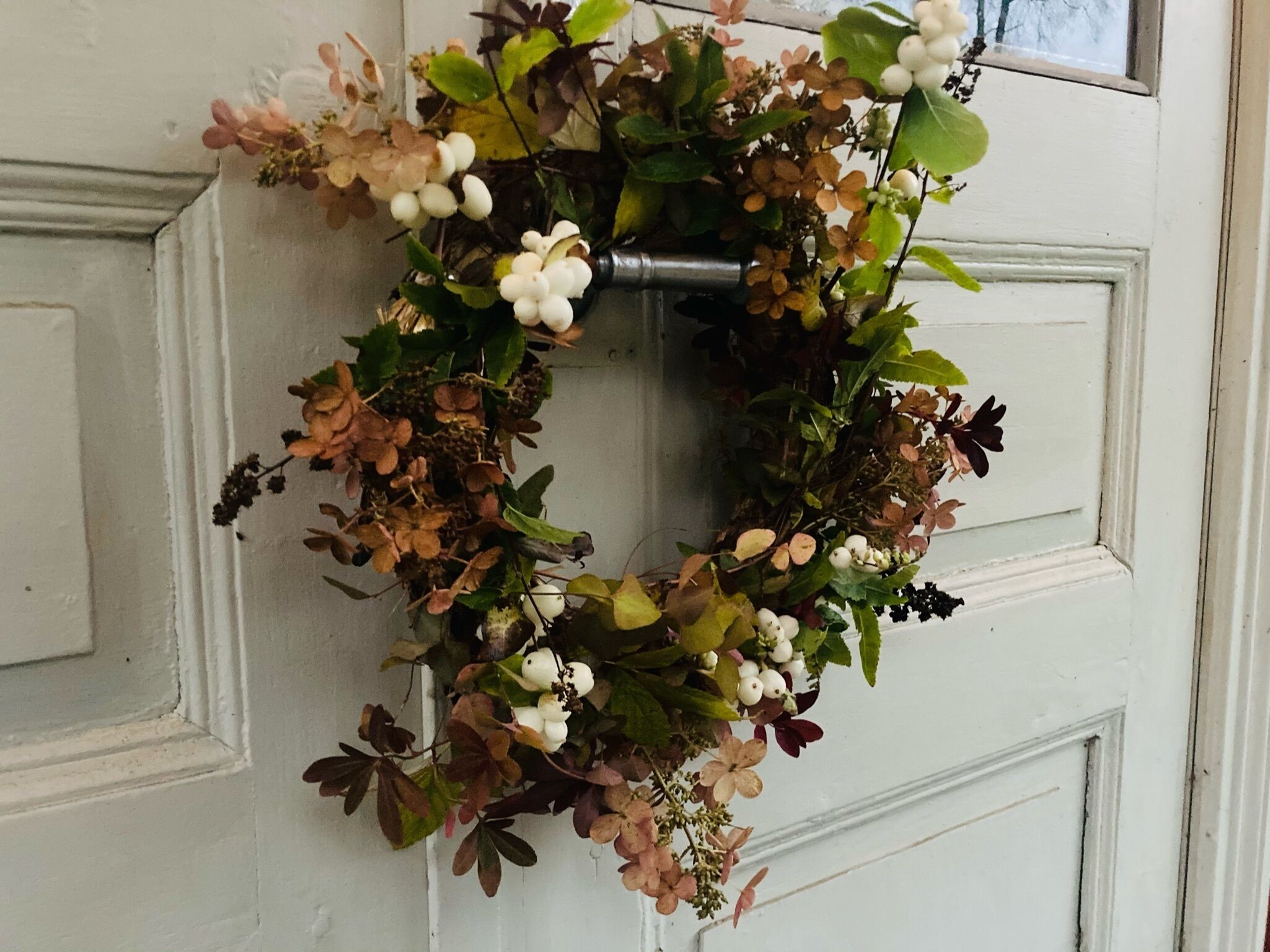 A wreath on a white door.