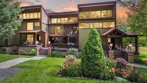 A two-story building with a covered patio and a staircase leading to the entrance. - Majestic Mountain Retreat | AC, Pool, Hot Tub, Golf & Ski (Durango)