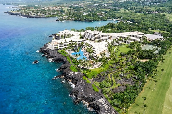 Soar above an oceanfront resort perched on lava-rock shores.